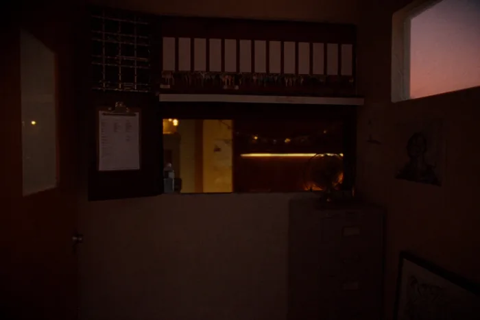 A wall-mounted key cabinet showing rows of keys on blank tags.